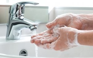 Washing of hands with soap under running water